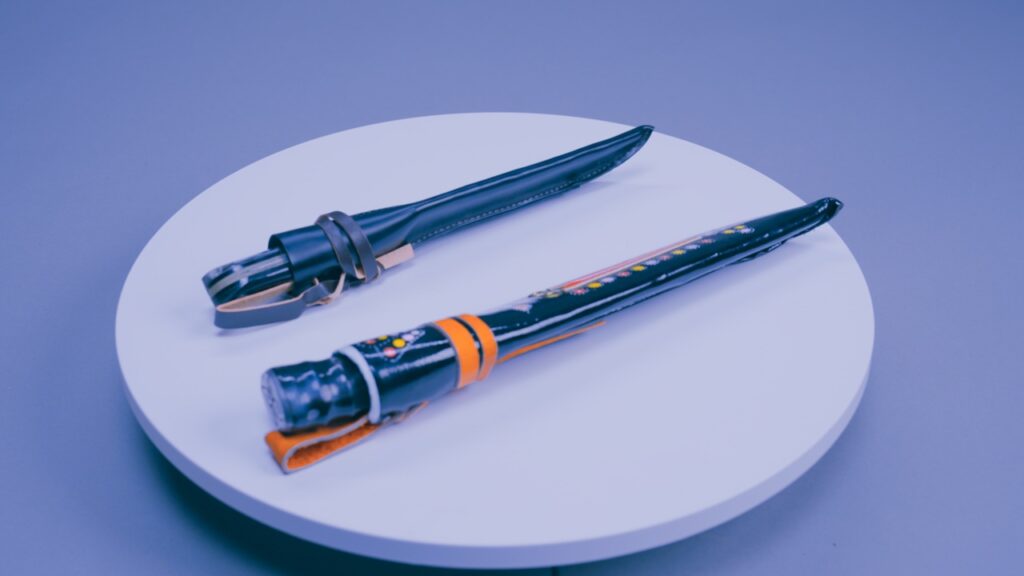Two traditional Namangan pichoq knives with leather sheaths, the style of blade made in Chust, Uzbekistan
