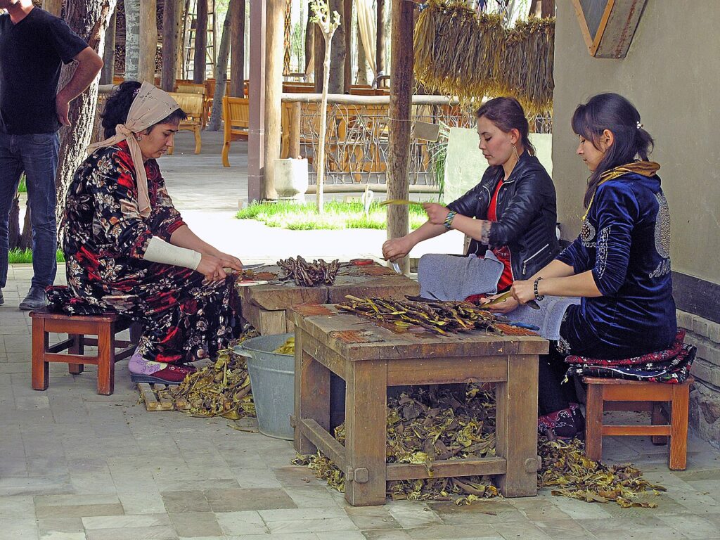 A craftsman peeling bark from mulberry branches at the Meros paper mill in Konigil village near Samarkand, Uzbekistan