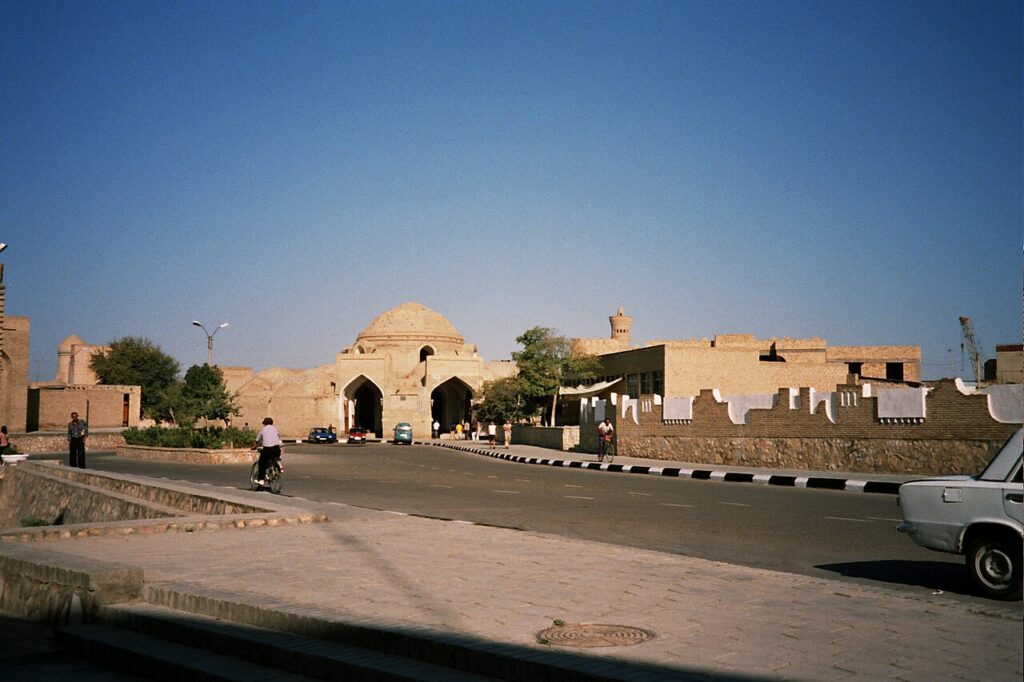 Hat and textile stalls under a domed trading arcade at the cap makers bazaar in Bukhara, Uzbekistan