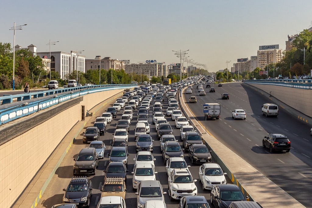 Heavy car traffic on a wide Tashkent street, where most taxis are ordinary private cars