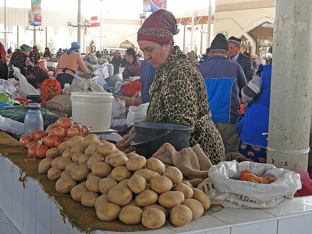 A vegetable seller at Bukhara's central bazaar, where the cheapest and freshest breakfast in the city is sold